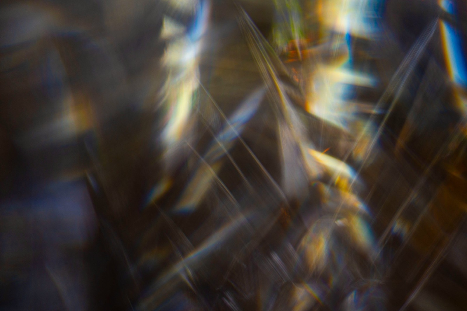 Abstract light reflections with sharp edges and blurred colorful refractions.
